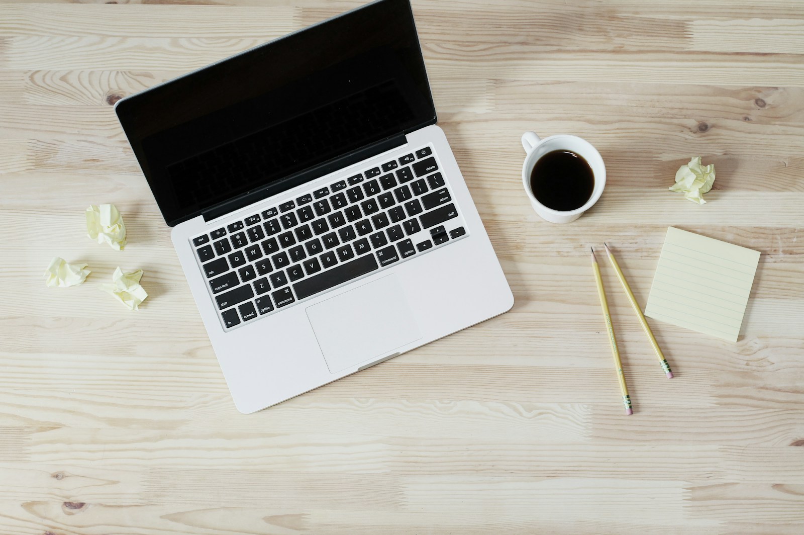 coffee latte near white wireless keyboard and Apple EarPods on the table photography